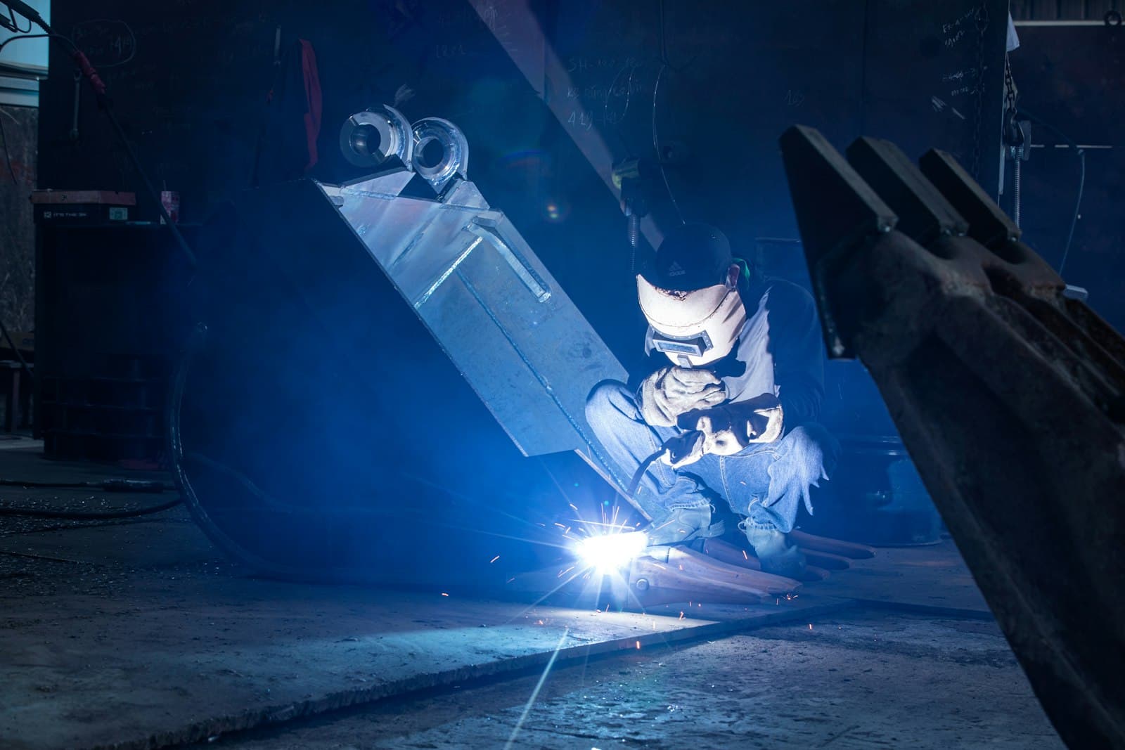 Angle grinder throwing sparks across a steel workpiece